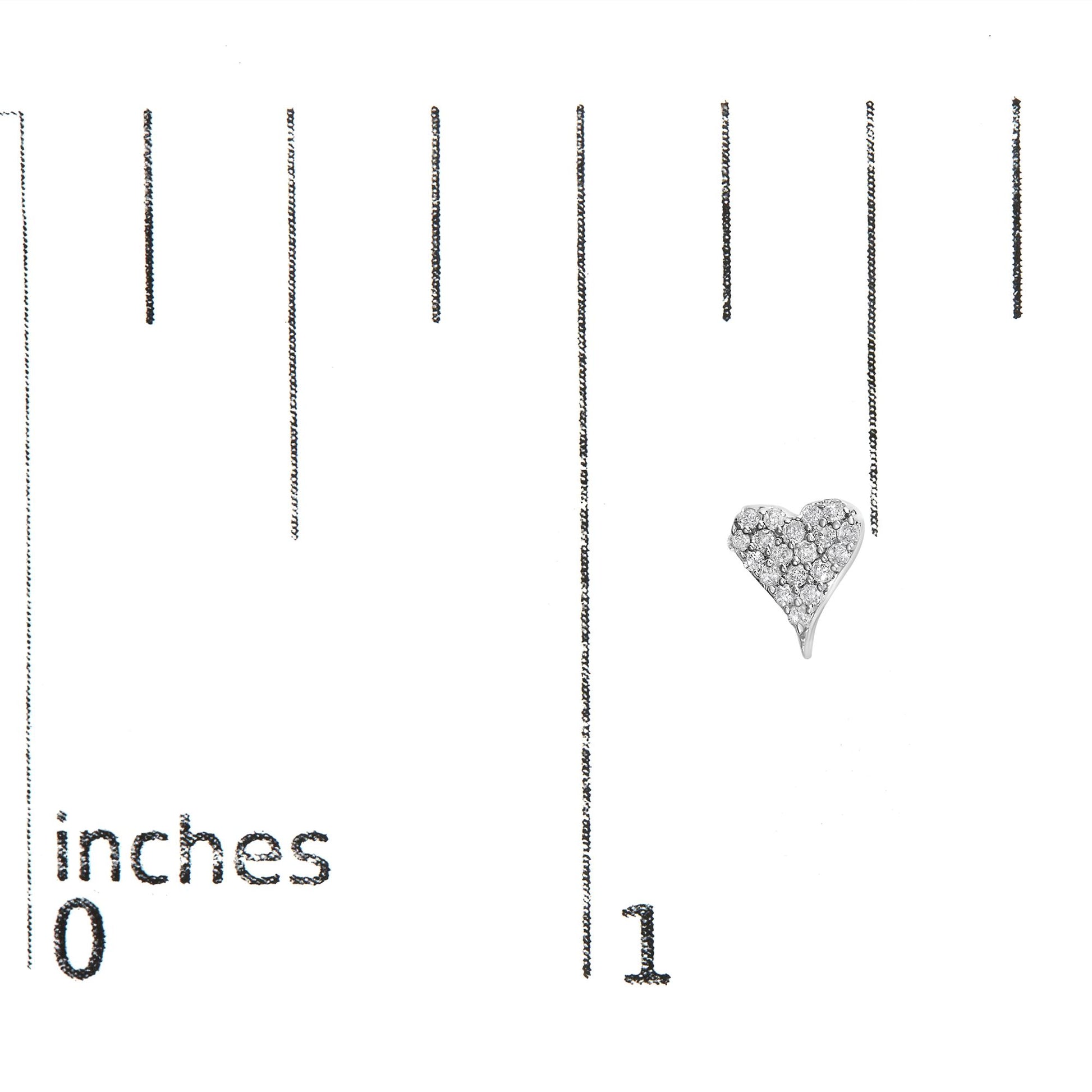Heart-shaped white metal earring with round white gemstones in prong setting, shot from the front on a ruler for size reference.