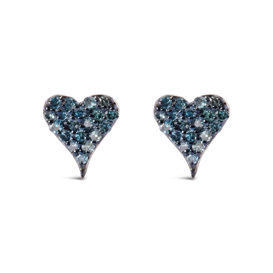 Front angle view of a pair of white metal heart-shaped earrings adorned with round prong-set blue gemstones.