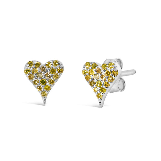 Pair of white metal heart-shaped stud earrings with round yellow gemstones in prong settings, shown from a front and side angle.