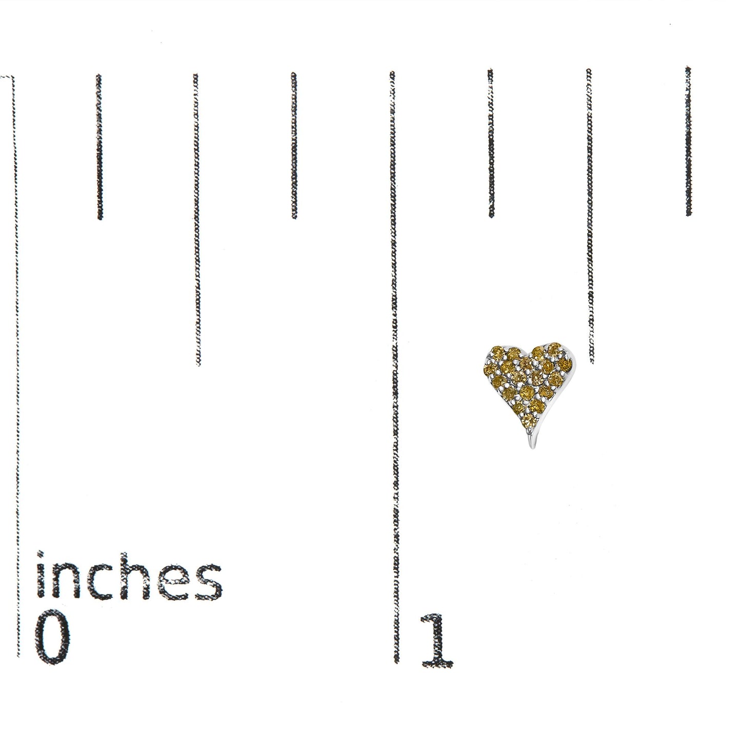 Close-up front view of a white metal heart-shaped earring adorned with round yellow gemstones in prong settings, placed on a ruler for size reference.