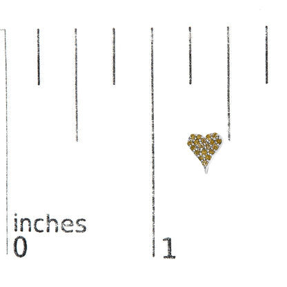 Close-up front view of a white metal heart-shaped earring adorned with round yellow gemstones in prong settings, placed on a ruler for size reference.