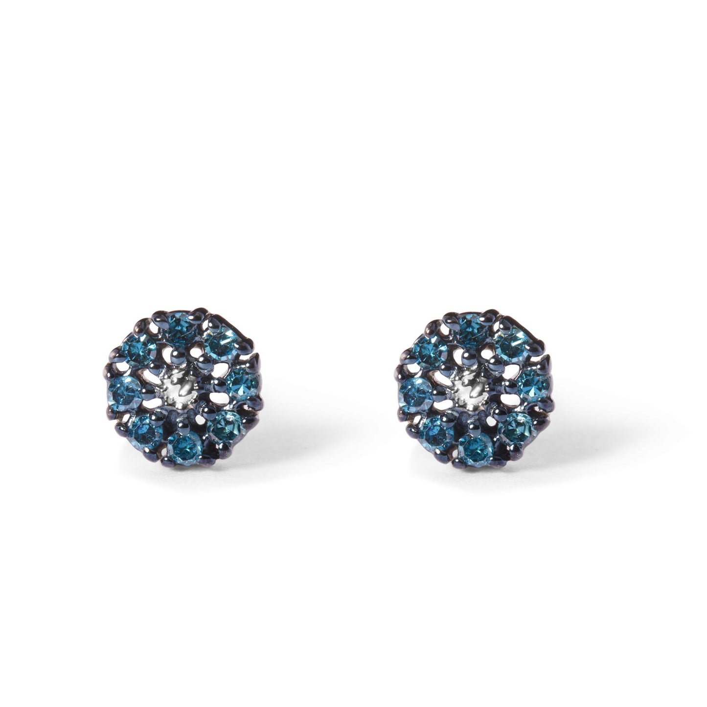 Pair of white metal round stud earrings with prong-set blue gemstones, shown in a front-facing close-up shot.