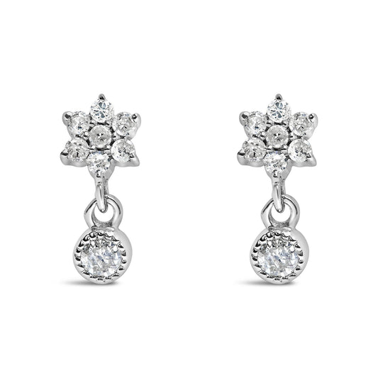 Front view of white metal earrings with round white gemstones in a prong setting, featuring a floral cluster and a single dangling gemstone.