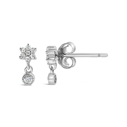Front and side view of white metal stud earrings with cluster of round white gemstones in prong setting and a single round white gemstone drop, shown on a white background.