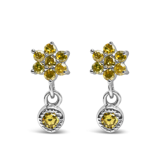 Front view of white metal earrings with cluster of yellow round gemstones at the top and a single yellow round gemstone dangle below.