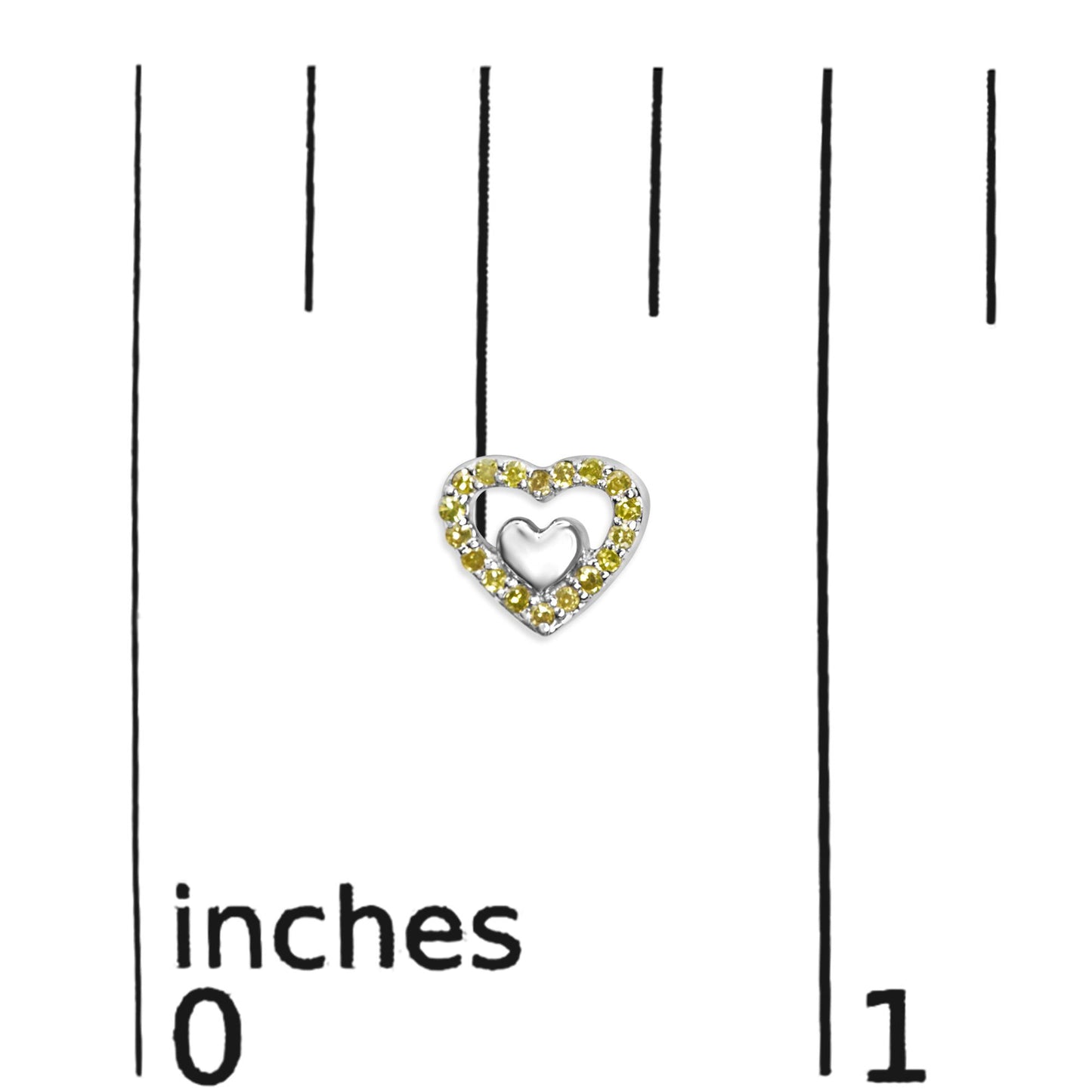 Close-up front view of a white metal heart-shaped earring with yellow round prong-set gemstones, displayed on a ruler for size reference.
