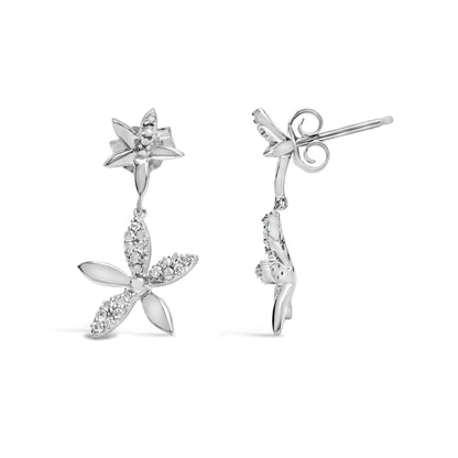 Front and side view of white metal floral drop earrings with petals accented by white round gemstones in prong settings, shown on a white background.