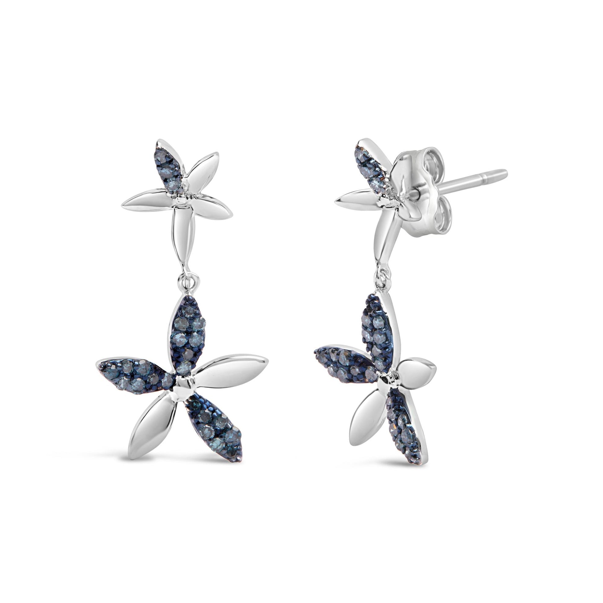Pair of white metal earrings with flower design, featuring alternating smooth and blue gemstone-encrusted petals, shown in a front and side angle on a white background.