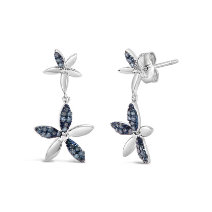 Pair of white metal earrings with flower design, featuring alternating smooth and blue gemstone-encrusted petals, shown in a front and side angle on a white background.