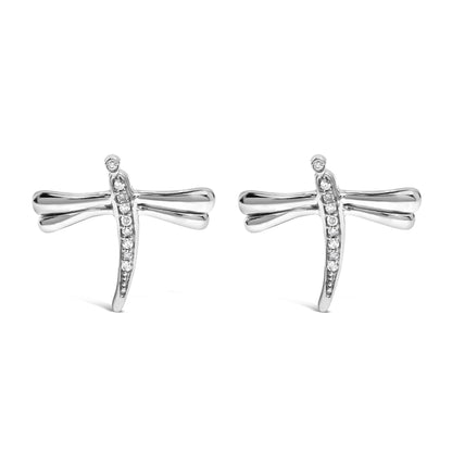 Front angle view of a pair of white metal dragonfly-shaped earrings with round white gemstones set along the vertical body and at the tip of one wing.