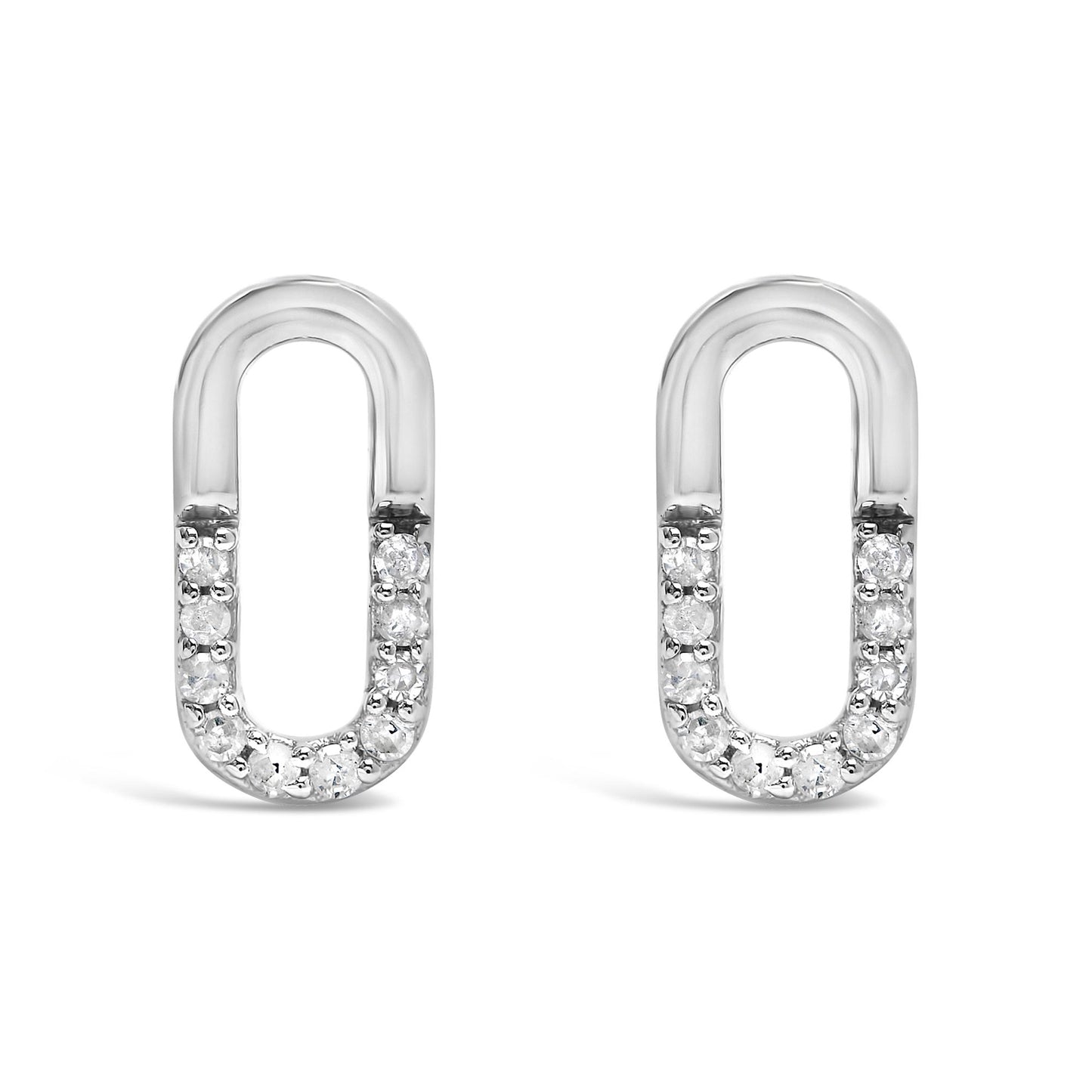 Front view of a pair of white metal oval-shaped earrings with round white gemstones set in prongs along the bottom half.