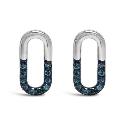 Front view of a pair of white metal oval-shaped earrings featuring blue round gemstones set in prongs along the lower half.