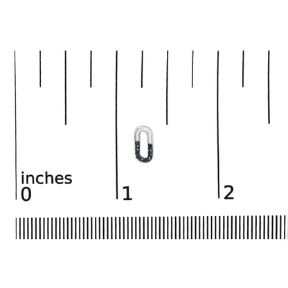 Close-up front view of small white metal earring partially encrusted with round blue gemstones, placed on a ruler for size reference.