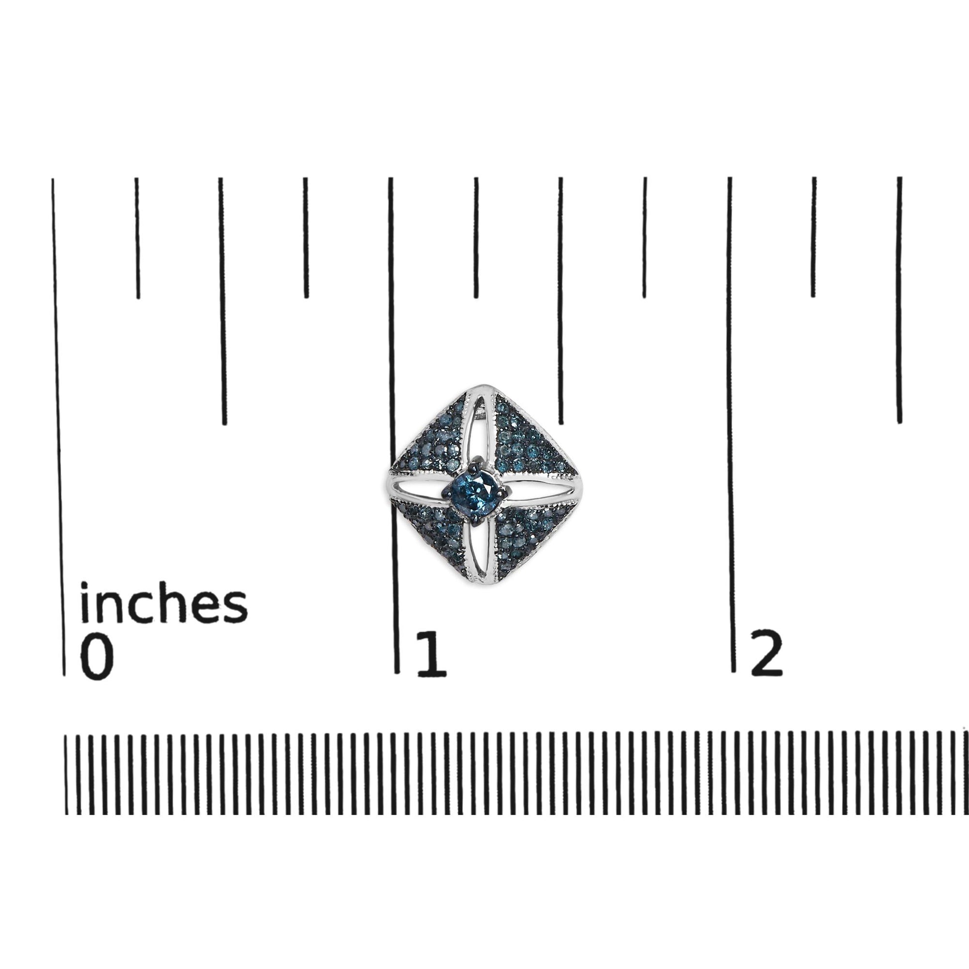 White metal earring with a square design featuring two larger round blue gemstones in prong setting at the center, surrounded by numerous smaller round blue gemstones in prong setting, shown on a ruler for size reference, photographed from the top.