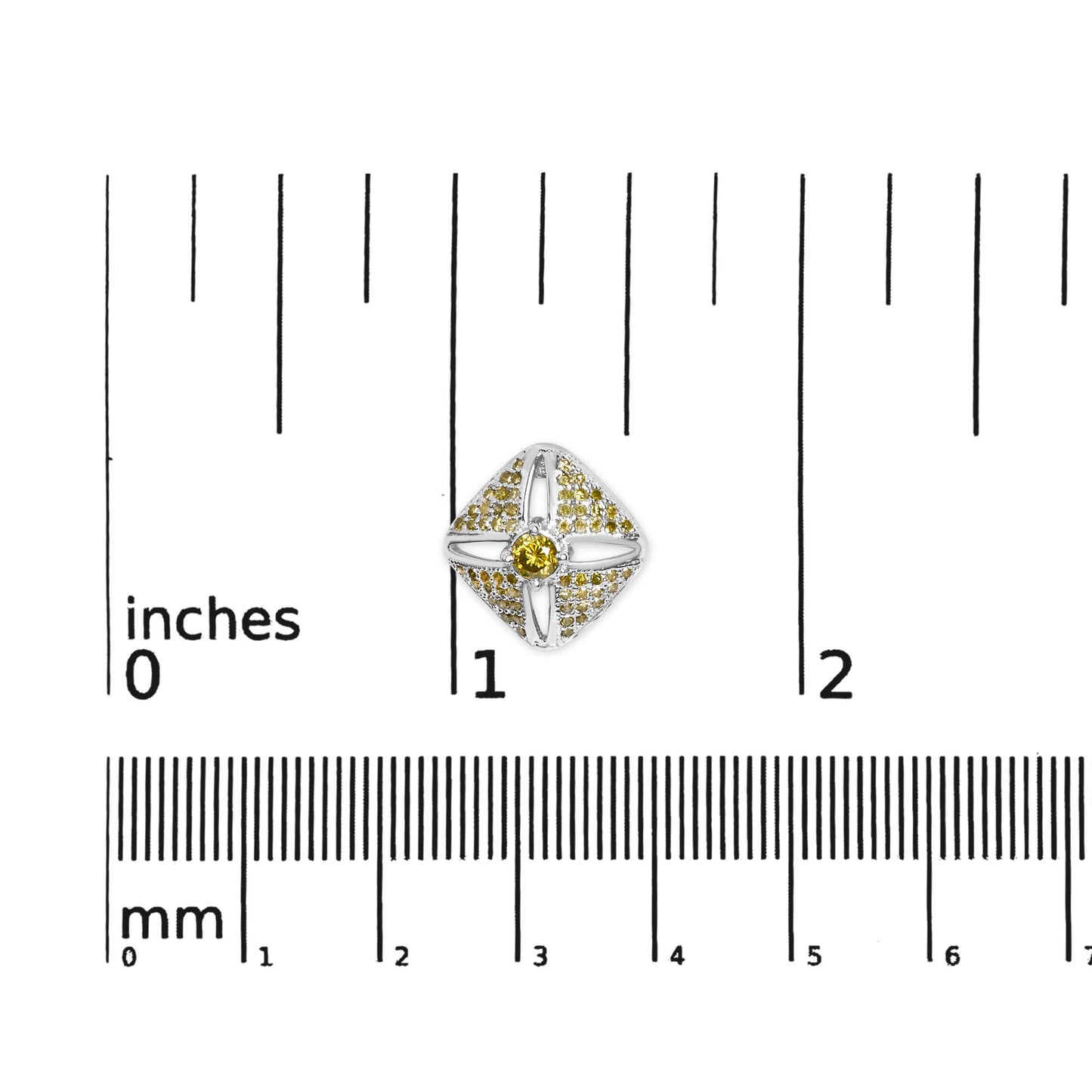 Top-down view of a white metal earring with a central round yellow gemstone and multiple smaller yellow gemstones arranged around it, placed on a ruler for size reference.