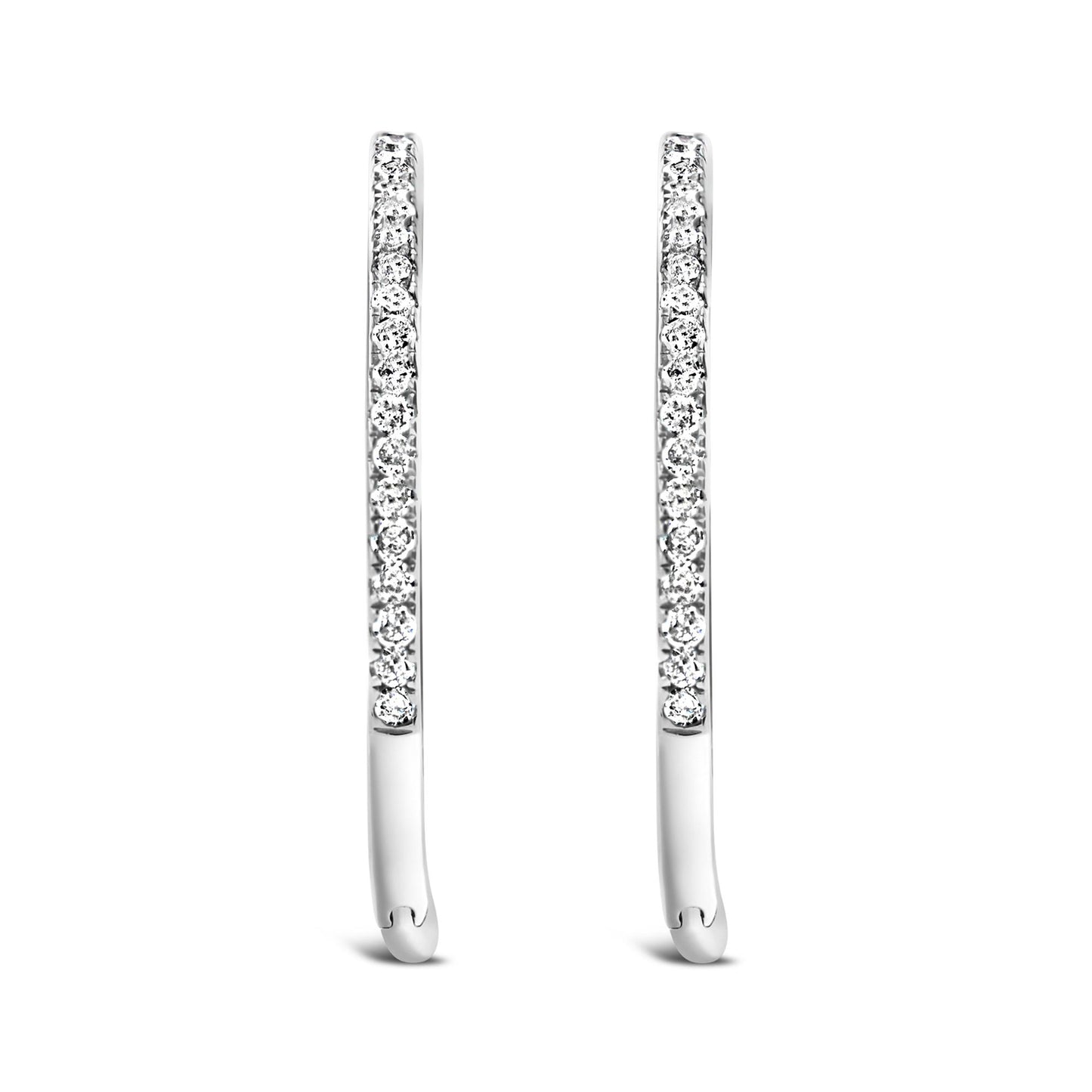 Front angled view of a pair of slim white metal earrings set with round white gemstones in prong settings.