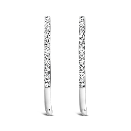 Front angled view of a pair of slim white metal earrings set with round white gemstones in prong settings.