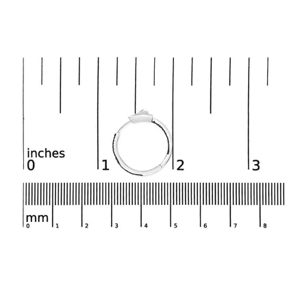 White metal hoop earring with prong-set round blue gemstones, positioned flat on a ruler for size reference, top-down view.