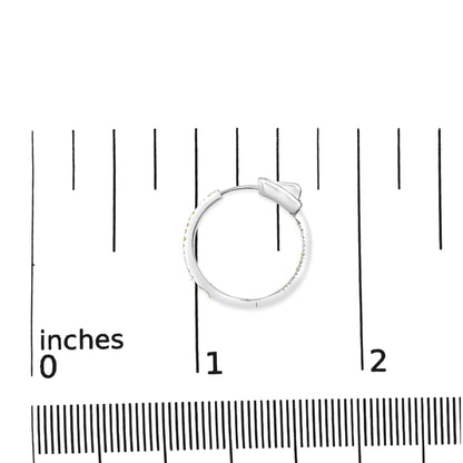 White metal hoop earring with small yellow round gemstones in prong setting, shown flat on a ruler for size reference, top-down angle.
