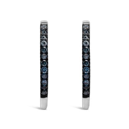 Pair of white metal hoop earrings, each set with small round blue gemstones in prong settings, viewed from the front.