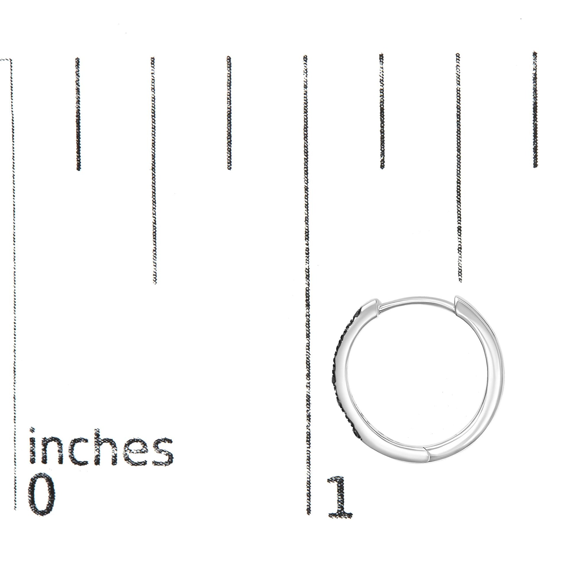 White metal hoop earring with prong-set blue round gemstones on the side, shown flat on a ruler for size reference.