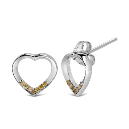 Front and side angled view of white metal heart-shaped stud earrings with small round yellow gemstones along the bottom edge.
