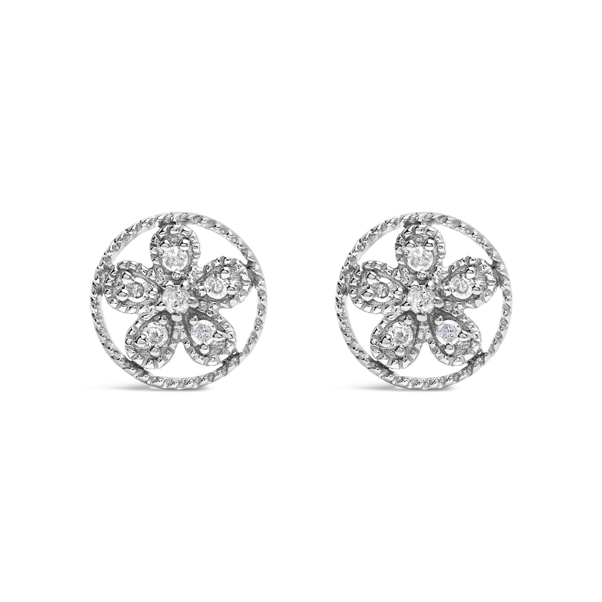 Front angle view of white metal round earrings with a flower design featuring round white gemstones in prong settings.