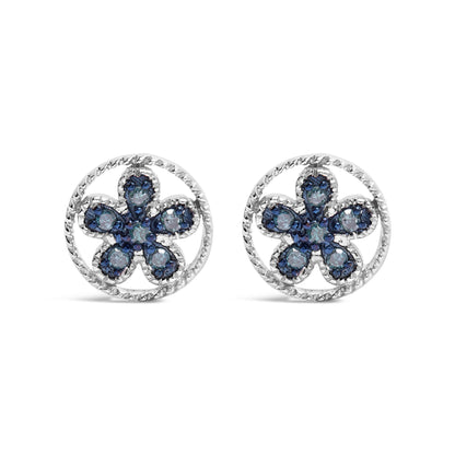Front view of white metal earrings with circular twisted borders and flower-shaped clusters of blue round prong-set gemstones.