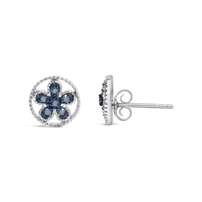 Front and side view of white metal stud earrings with a flower design featuring round blue gemstones in prong settings.