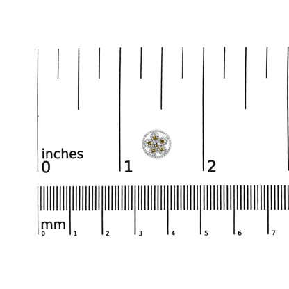 Close-up top view of a single white metal earring with yellow round gemstones in a prong setting, positioned on a ruler for size reference.