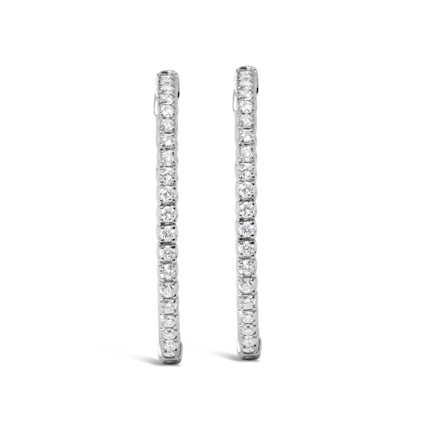 Front-facing view of a pair of white metal hoop earrings with round white gemstones in prong settings along the outer edge.