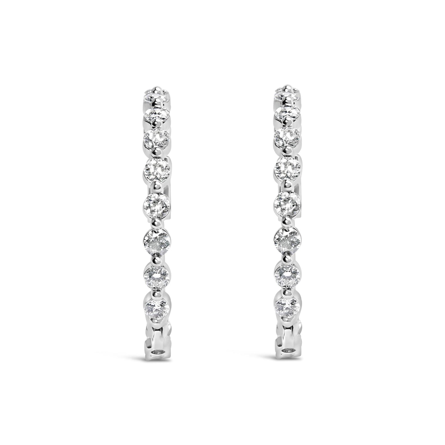 Front-facing view of a pair of white-colored metal hoop earrings, each adorned with a row of round white gemstones in 2-prong settings.