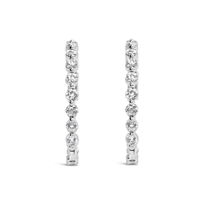 Front-facing view of a pair of white-colored metal hoop earrings, each adorned with a row of round white gemstones in 2-prong settings.