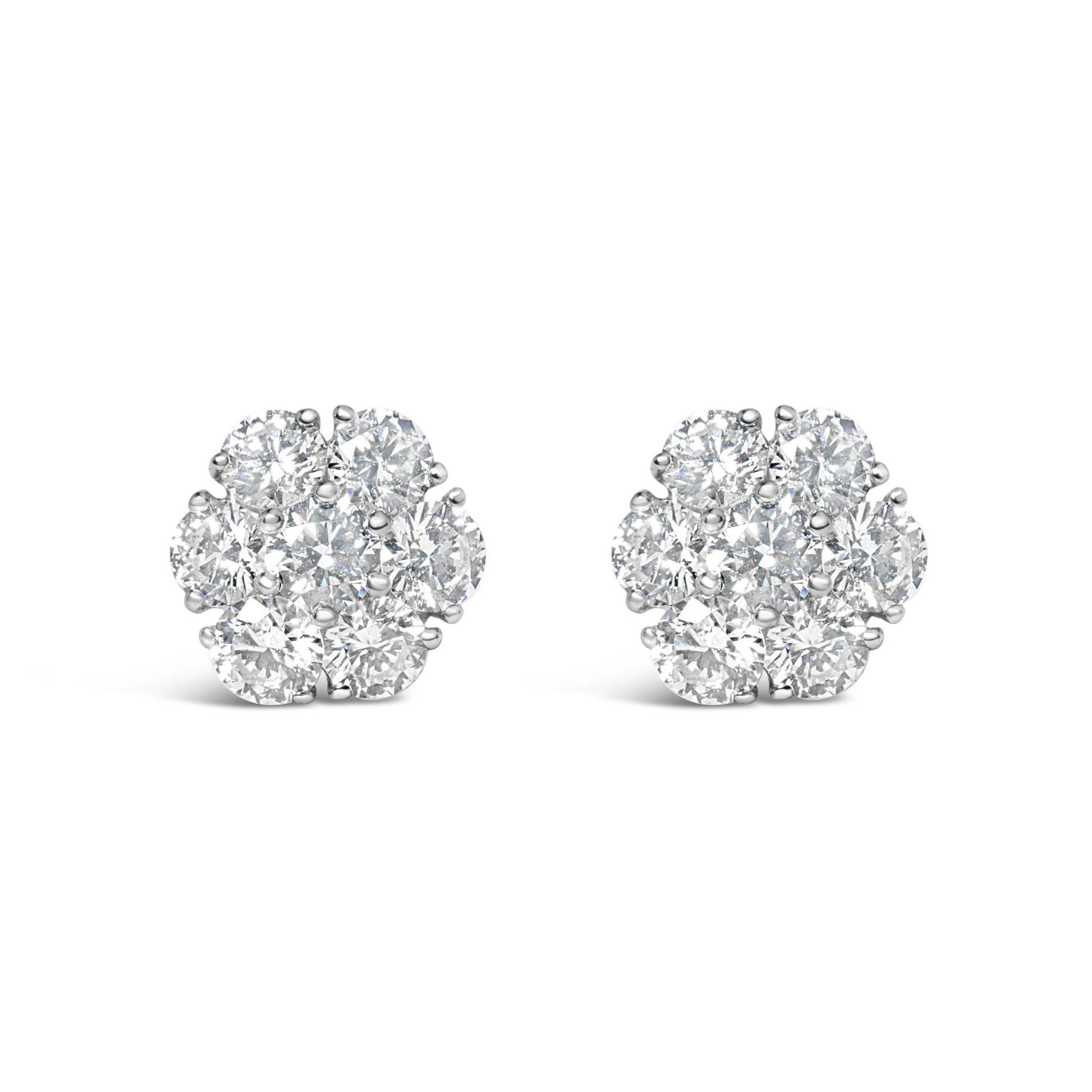 Front view of a pair of white metal cluster earrings featuring round white gemstones in prong settings.
