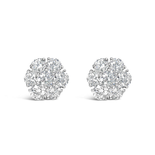 Front view of a pair of white metal cluster earrings featuring round white gemstones in prong settings.