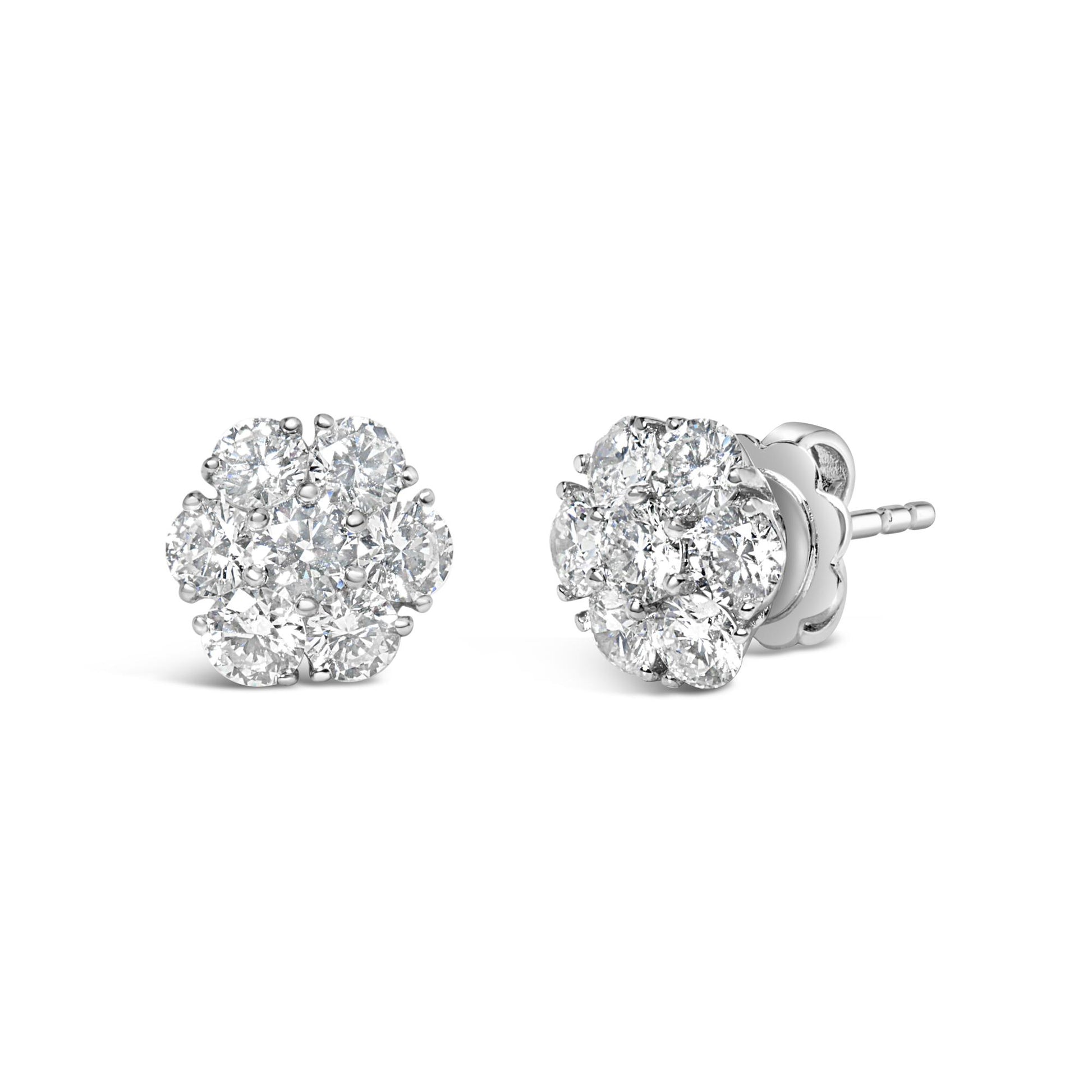 Pair of white metal stud earrings with round white gemstones arranged in a flower shape, shown from the front and side angle on a white background.