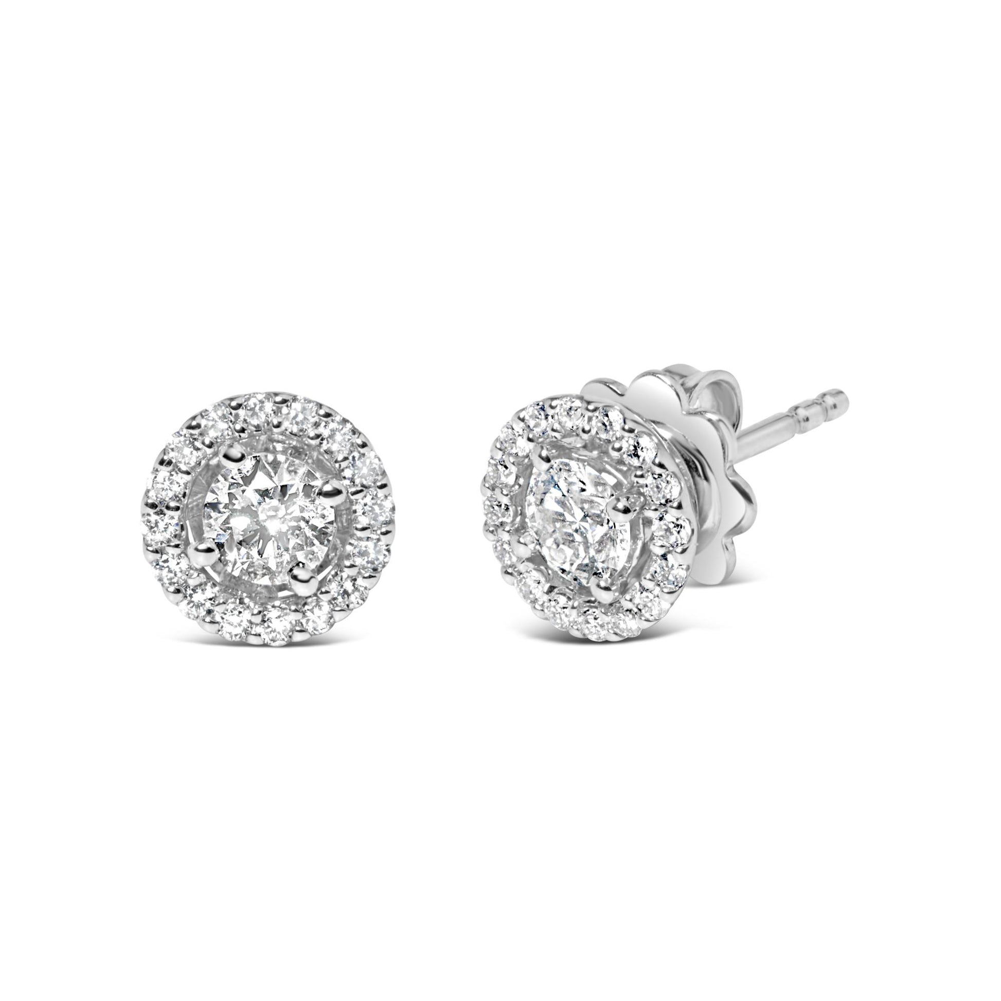 Pair of white metal stud earrings with round white gemstones in prong settings, shown in a front and angled side view on a white background.