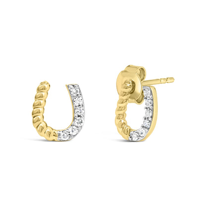 Close-up front and side view of small yellow metal hoop earrings with twisted design and prong-set white round gemstones on one side.