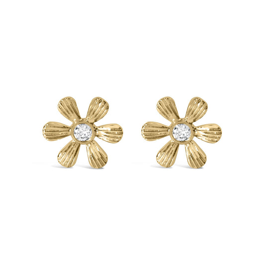 Pair of yellow metal flower-shaped earrings with textured petals and a round white gemstone in prong setting at the center, front-facing angle.