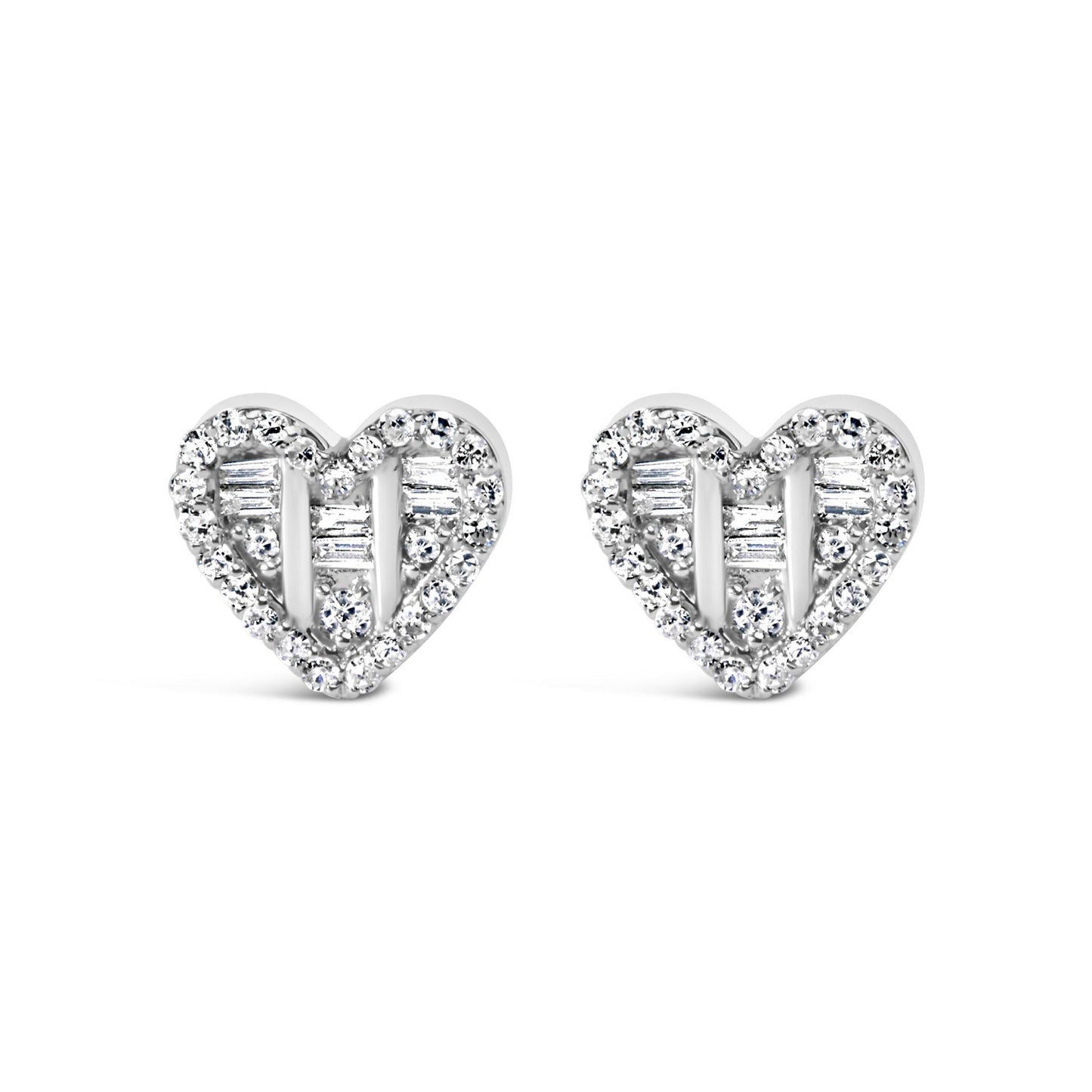 Front-facing shot of a pair of white heart-shaped earrings with round and baguette white gemstones in prong and channel settings.