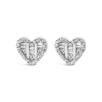 Front-facing shot of a pair of white heart-shaped earrings with round and baguette white gemstones in prong and channel settings.