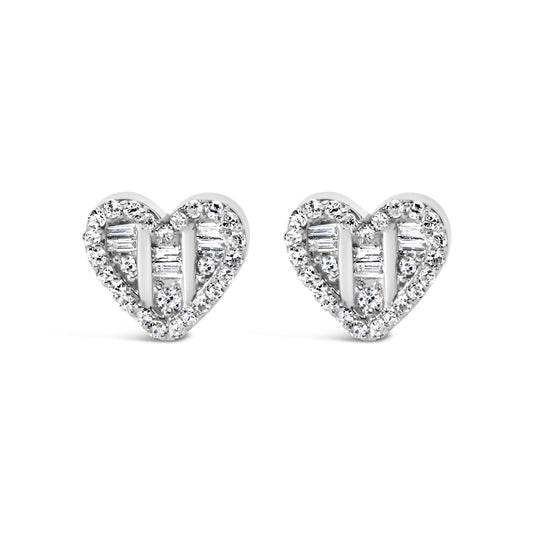 Front-facing shot of a pair of white heart-shaped earrings with round and baguette white gemstones in prong and channel settings.