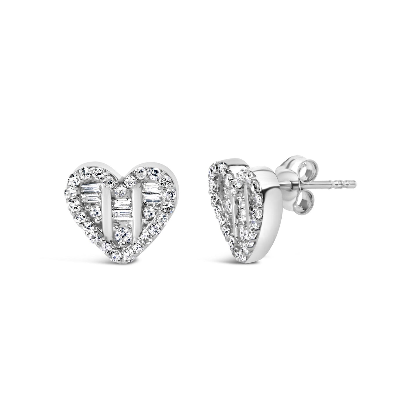 Front and side angle of white metal heart-shaped earrings studded with round and baguette white gemstones.