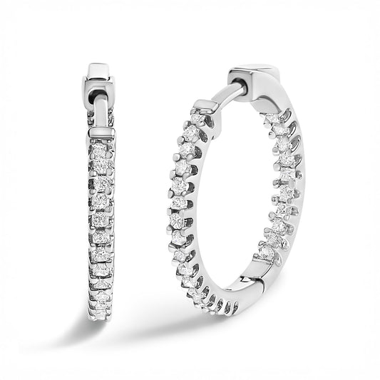 Close-up front and side view of white metal hoop earrings adorned with prong-set white princess shape gemstones.