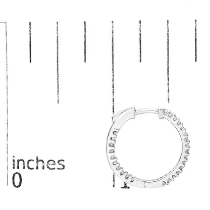 White metal hoop earring with prong-set princess shape white gemstones, shown from the front on a ruler for size reference.