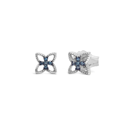 Front-facing shot of white metal earrings with a flower-like design featuring round blue gemstones in prong settings.