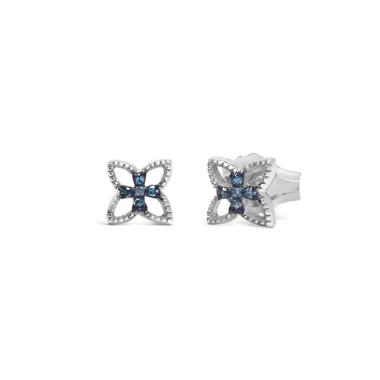 Front-facing shot of white metal earrings with a flower-like design featuring round blue gemstones in prong settings.