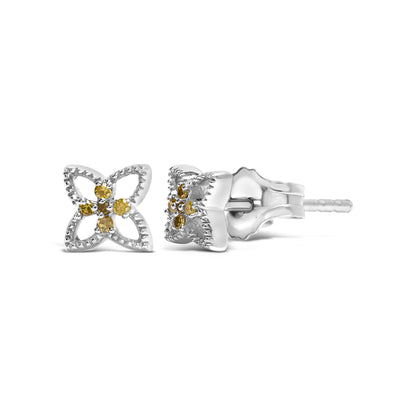 Pair of white metal stud earrings with a four-petal flower design featuring round yellow gemstones in prong settings, shown from front and side angles.