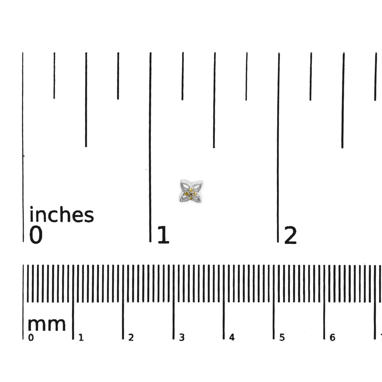 White metal earrings with a floral design featuring round yellow gemstones in prong settings, shown on a ruler for size reference, top-down angle.
