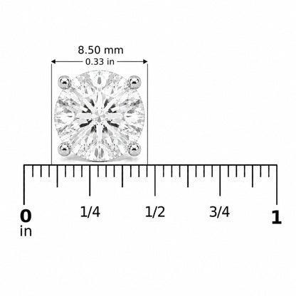 Close-up front view of a white earring with a round white gemstone in a four-prong setting, shown on a scale.